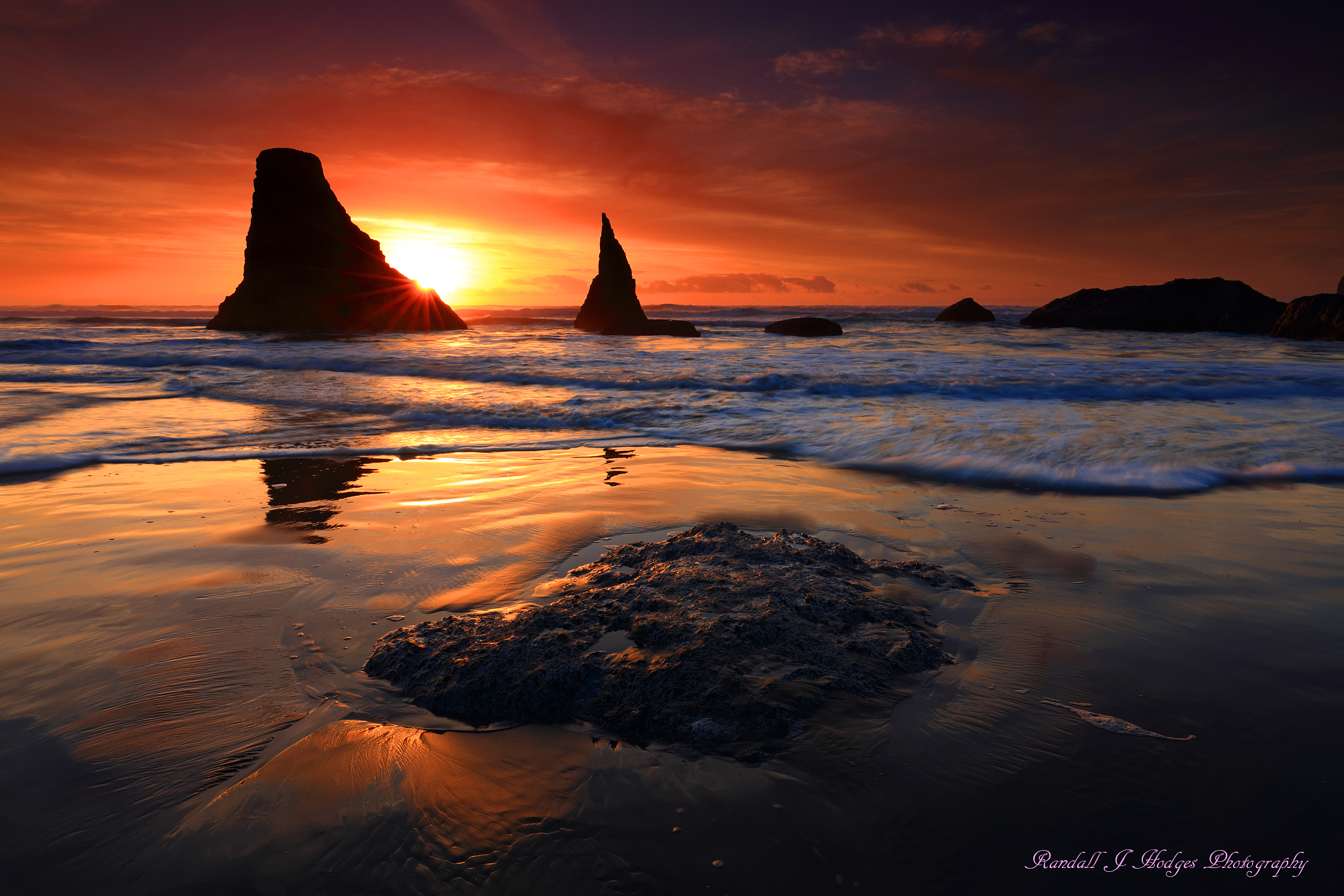 Sunset and Sun Star with the Wizards Hat Sea Stack in the Surf From Face Rock Beach in Bandon Oregon