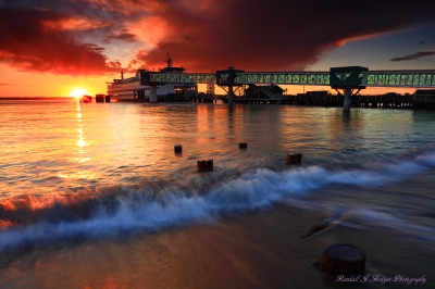 Sunset Edmonds Ferry at Dock with Wave From Brackett's Landing at Edmonds Beach in Edmonds Washington