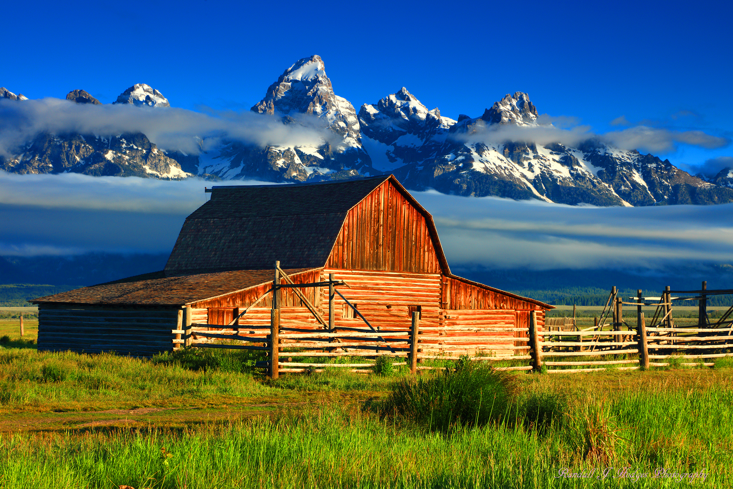 Morning Light and the John Moulton Barn With the Grand Tetons from Morman Row in Grand Teton National Park in Wyoming