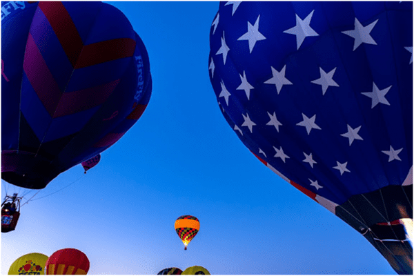 A group of hot air balloons flying in the sky.