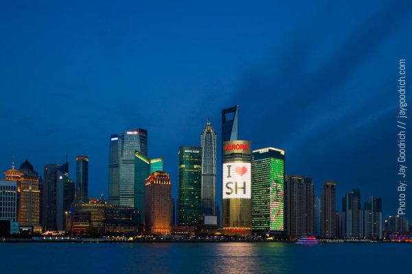 The skyline of shanghai is lit up at night.