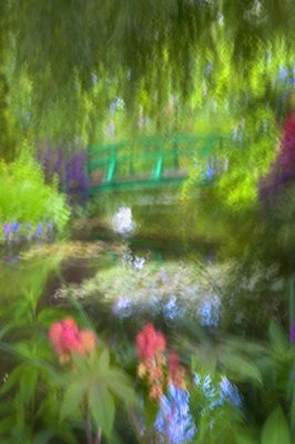 A green bridge over a pond.