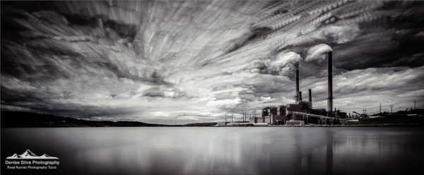 Black and White Photo of a Power Plant with a Lake in the Foreground