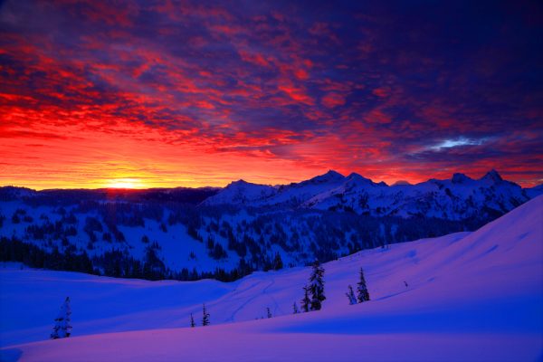 Photo of a Red Sunrise over a Snowy Mountain