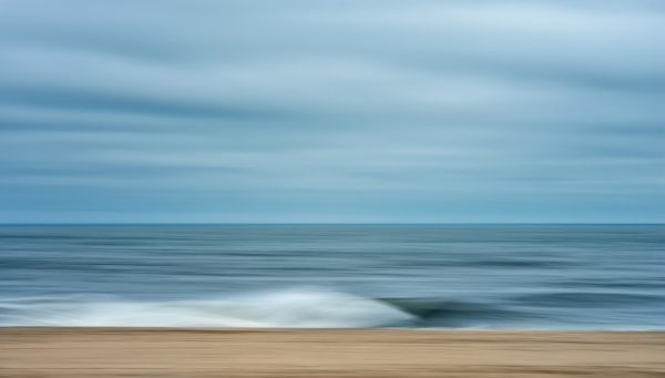 Photo of a beach with calm waves