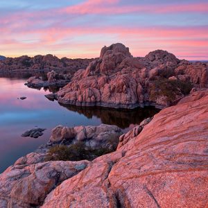 Rocky landscape with a lake at sunset.