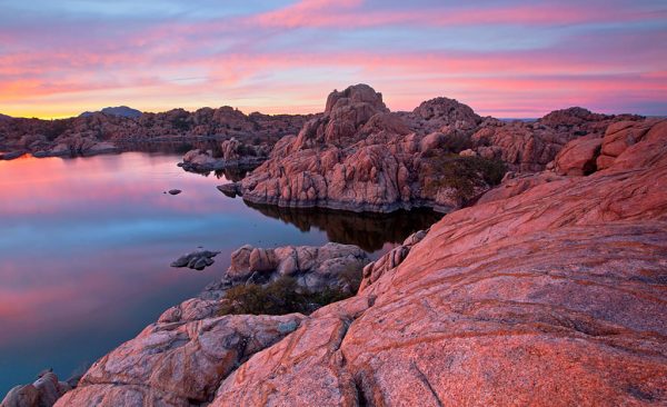 Rocky landscape with a lake at sunset.