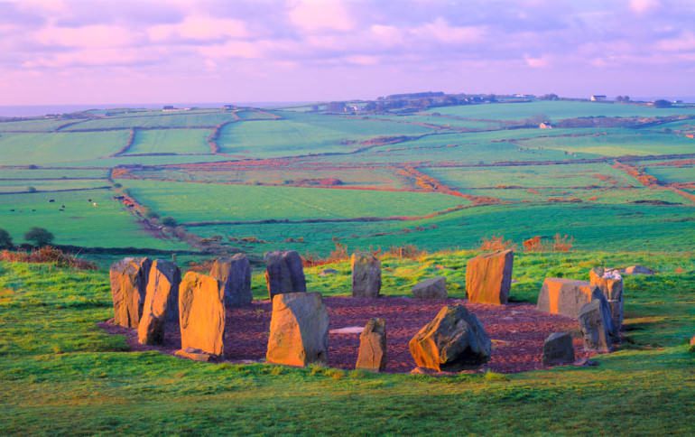Stone circle on a hill overlooking fields.