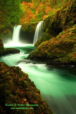 Waterfall cascading over mossy rocks.