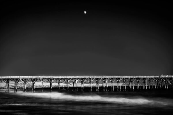 Black and white photo of a pier at night.