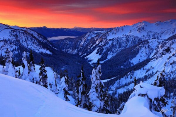 Snowy mountain range at sunset.